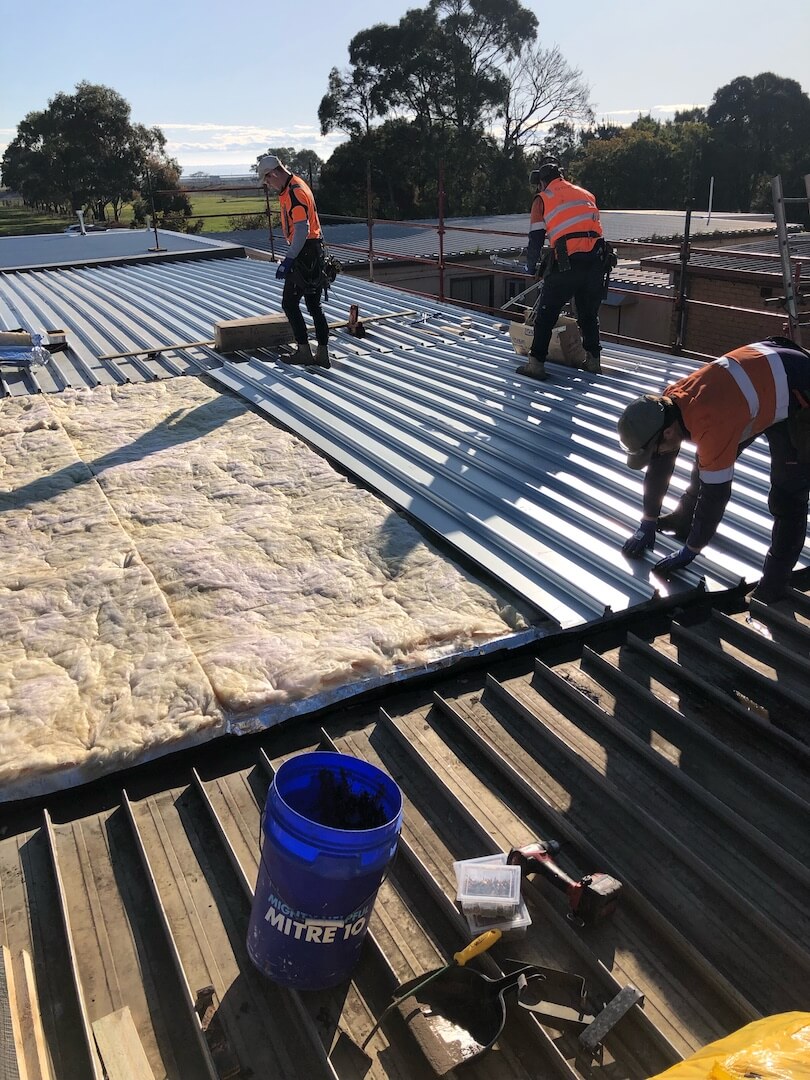 Dow Administration rooftop with plumbers working